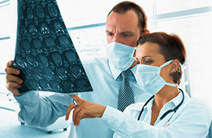Doctors Looking At Brain Scans