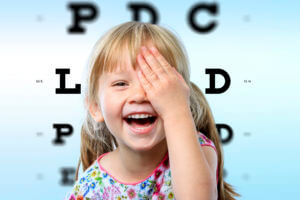 Little Girl Covering Eye To Read Eye Chart